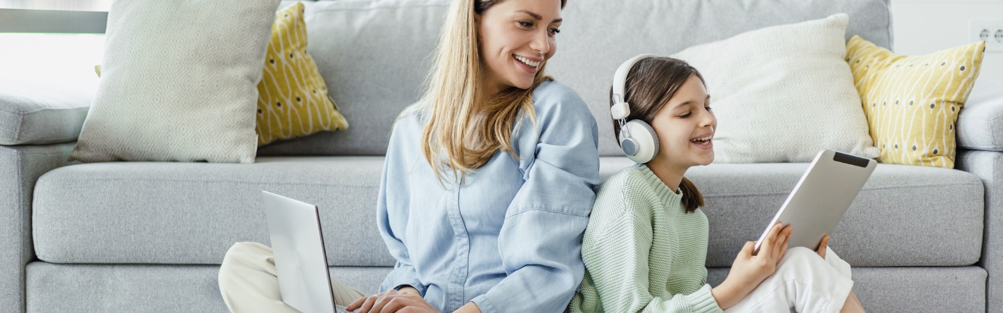 cheerful-mother-and-daughter-using-wireless-technology