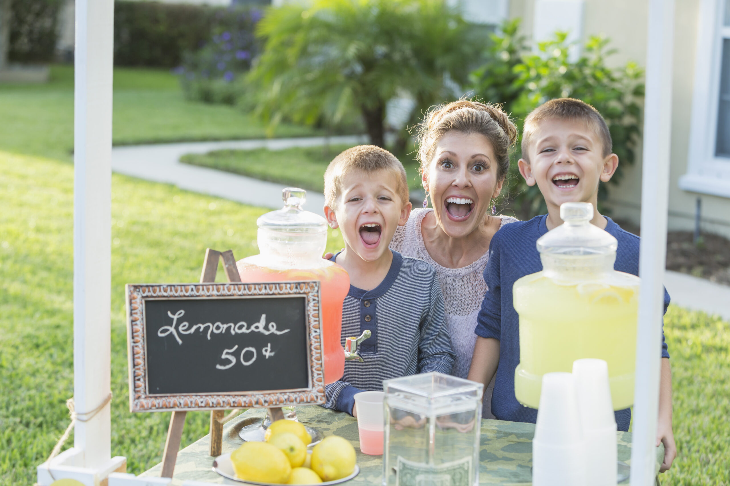Financial wins. Mother and boys with lemonade stand.