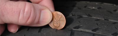 Inspecting tire tread using a penny.